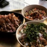 Samosa Chaat · Served with chickpeas, onions, cilantro, sweet chutney and spicy chutney. Vegetarian.