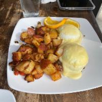Eggs Benedict · Canadian bacon, poached eggs over English muffin topped with Hollandaise sauce. Served with ...