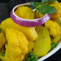 Aloo Gobi · Fresh cauliflower, potatoes and green peas delicately spices and served with tomato and onio...
