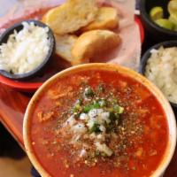 Menudo · Beef row soup with hominy with a side of lime.