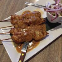 Chicken Satay · Grilled chicken on skewers, marinated in turmeric-coconut milk, and served with cucumber sal...
