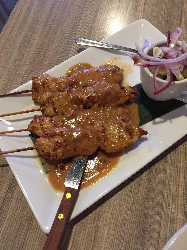 Chicken Satay · Grilled chicken on skewers, marinated in turmeric-coconut milk, and served with cucumber salad and peanut sauce.
