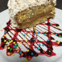 Chaja · Luscious Uruguayan sponge cake filled with peaches, whipped cream, dulce de leche, and toppe...
