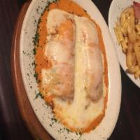 Canelones · Beef, spinach or chicken cannelloni on Alfredo, pink or marinara sauce and melted cheese.
