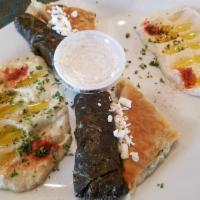 Dolma · 5 pieces. Homemade stuffed grape leaves made with rice, herbs and spices, steamed in savory ...