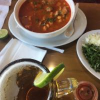 Pozole · Served with hominy, pork meat, garnished, onions, cabbage, radish, tortillas.