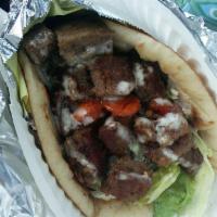 Lamb Gyro · Includes homemade tzatziki sauce, lettuce, tomato and onion on fresh warm pita bread.
