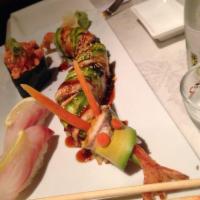 Dragon Roll · Shrimp tempura and cucumber inside, eel and avocado on top with eel sauce. 
