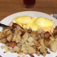 Eggs Benedict · 2 poached eggs with bacon or Canadian bacon on an English muffin. Topped with homemade Holla...