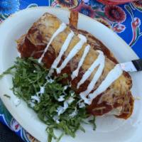 Wet Burrito · Our corazón burrito smothered in red enchilada sauce, melted cheddar Jack cheese, and lime c...