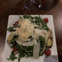 Arugula Salad · Arugula, shaved fennel, Parmesan cheese, roasted tomatoes, artichoke, and lemon herb vinaigr...