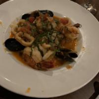 Seafood Risotto · Arborio rice served with clams mussels, shrimp, calamari in a white wine tomato sauce.