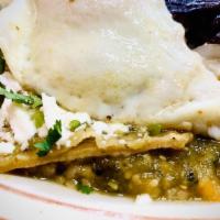 Chilaquiles · Fried tortillas covered with choice of sauce. Served with rice beans, sour cream, cheese, an...