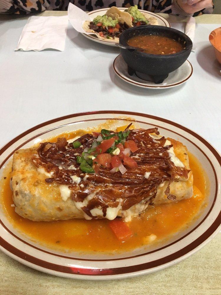 Burrito Suizo · Cecina, steak, al pastor, or chicken. Topped with tomato, lettuce, beans, sour cream, and cheese. Covered with red sauce and melted sauce.