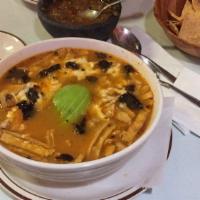 Sopa Azteca · Tortilla and chipotle soup. Topped with cheese and avocado.