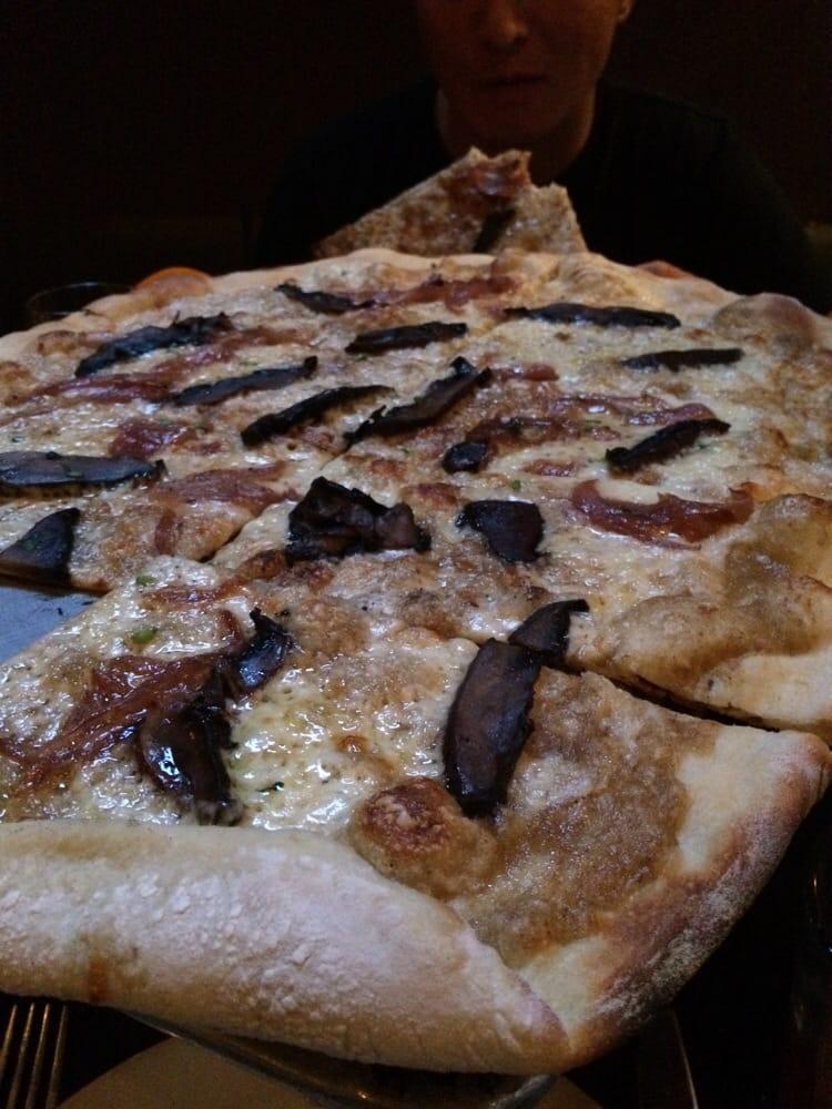 Portobello Pizza · Wild mushroom puree, portobello, red onions, fontina and truffle oil. Vegetarian.
