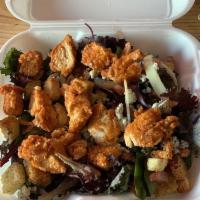 Buffalo Chicken Salad · Breaded chicken tossed in hot sauce, served over a lettuce blend with tomato, onion, Bleu ch...