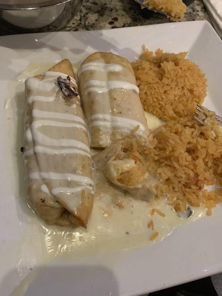 Seafood Chimichangas · 2 flour tortillas, fried or soft, filled with shrimp, crab meat, onions, and tomatoes covered with alfredo sauce. Served with rice, beans, and sour cream.