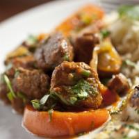Lamb Vindaloo · Cubes of lamb cooked in a sharply spiced chef's homemade sauce and potatoes. Served with bas...