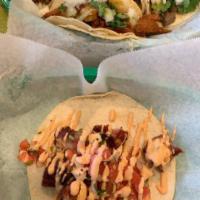 Mariachi Taco · Bacon wrapped shrimp in a tortilla with house toppings.