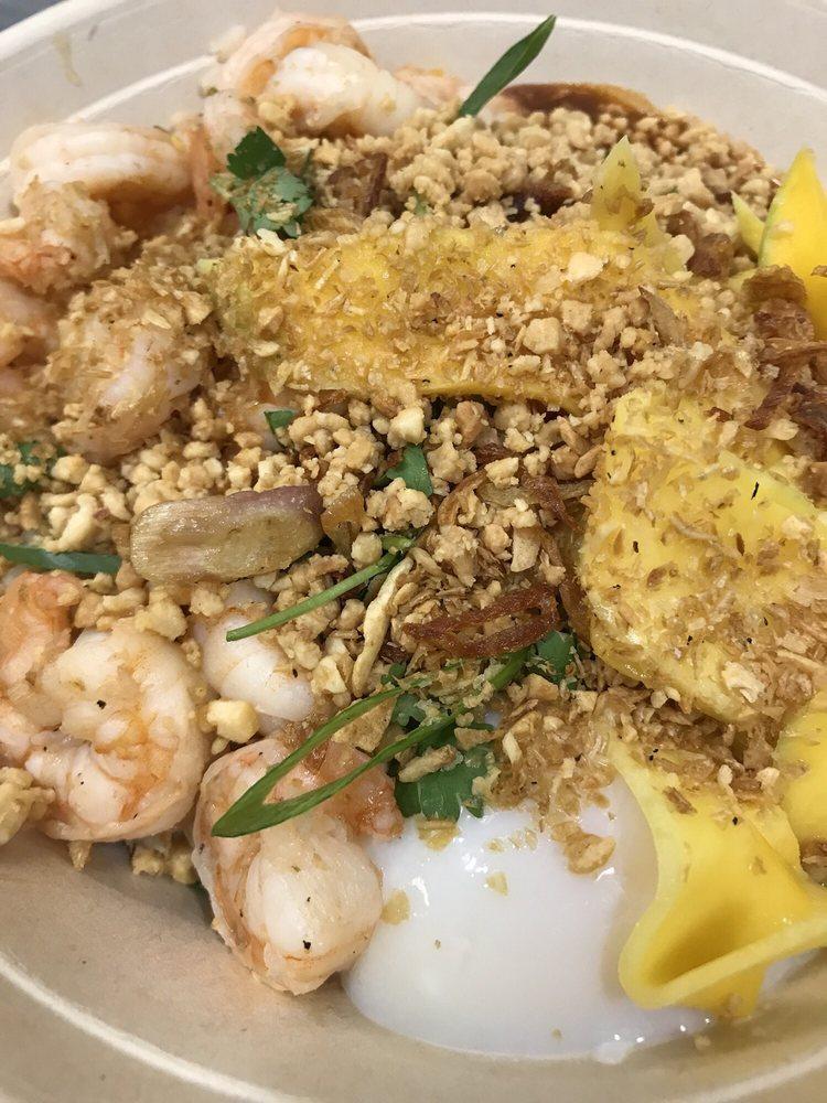 Bangkok · Seared shrimp, poached egg, mangoes, shallots, garlic, peanuts, scallions, cilantro, shrimp sambal and lime fish sauce with Thai chilies. Spicy.