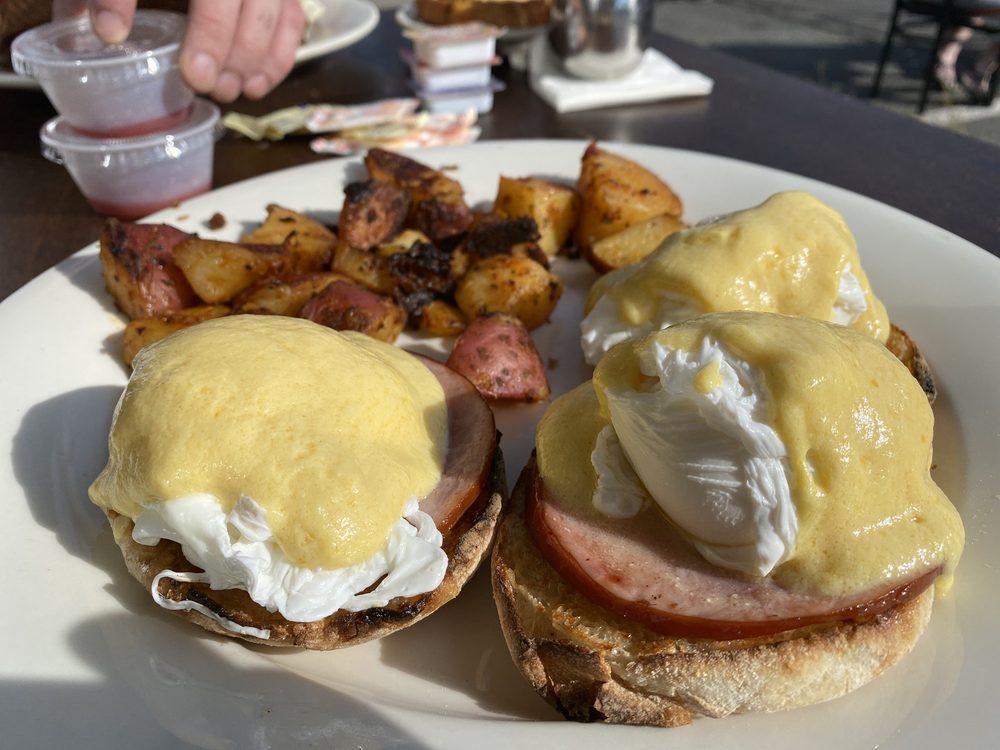 Eggs Benedict · Poached eggs on an English muffin with Canadian bacon and our own hollandaise sauce served with home fries. Add fresh spinach or tomato for an additional charge. Vegetarian: fresh spinach, tomato.