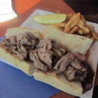 Prime Rib Sandwich · Sliced tender choice prime rib with au jus served on a French roll, served with french fries.