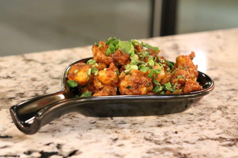 Gobi Manchurian · Cauliflower florets tossed in savory Indo-Chinese style sauce made from soya, vinegar, ginger, and spring onion