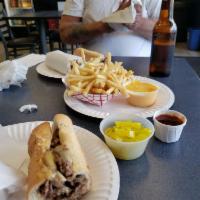 Traditional Cheesesteak · Choose thinly sliced steak or chicken breast with grilled onions and melted Boar’s Head Bran...
