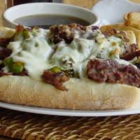 Italian Beef Sandwich · A sandwich composed of thin slices of seasoned roast beef, simmered and served au jus on a l...