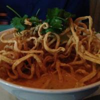Kao Soi · Egg noodles, shallots, cilantro, and pickle lettuces in Kao soi curry soup topped with crisp...