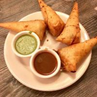 Samosa · Stuffed with potatoes, peas, spices and herbs with a side of tamarind chutney. Vegan. COMES ...