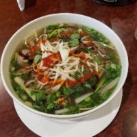 Pho Dac Biet · Rare steak slices, well-done brisket, tripe and beef balls in rice noodle soup.