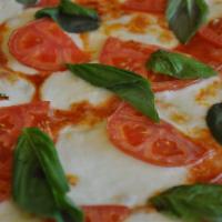 Margarita Pizza · Light tomato sauce, fresh mozzarella, basil, tomatoes and drizzled with olive oil.