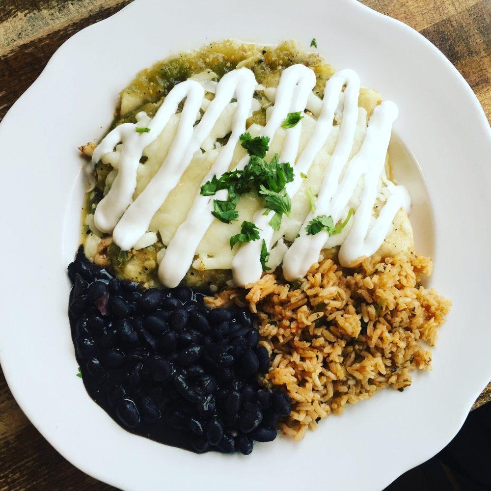 Enchiladas Verde · 2 corn tortillas stuffed with meat, cheese and house made verde sauce, topped with Mexican crema, served with rice and beans.