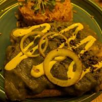 Verde Enchiladas · Green tomato, serrano peppers, shredded palm carnitas, coconut queso, served with Spanish ri...