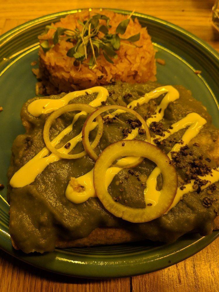 Verde Enchiladas · Green tomato, serrano peppers, shredded palm carnitas, coconut queso, served with Spanish rice. Spicy.