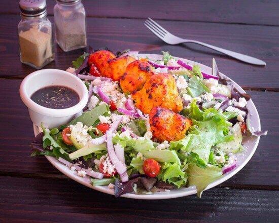 Kabob Salad · Spring mix, feta cheese, cucumber, cherry tomatoes, red onion, black olives, almonds, chicken kabob, and vinaigrette dressing on the side.