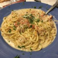 Seafood Pasta · Crab meat, lobster and shrimp tossed in a garlic cream sauce with capers on a bed of linguin...