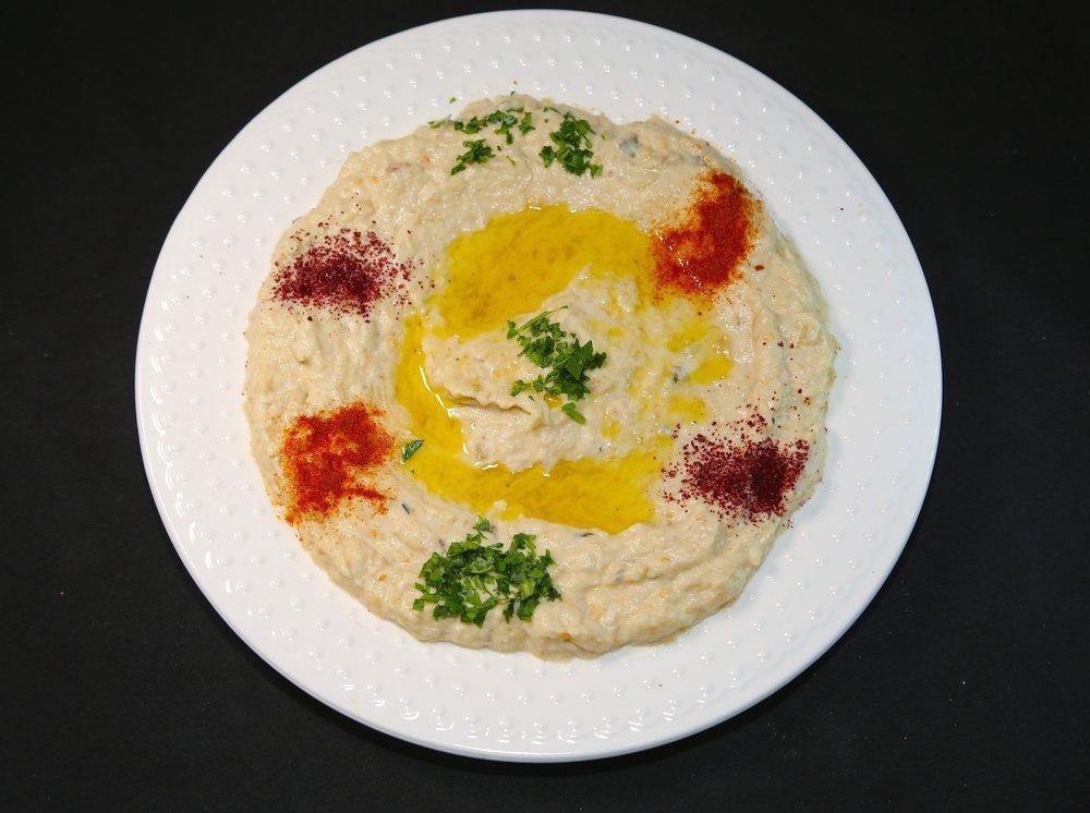 Baba Ghanoush · Baked eggplant blend with tahini sauce and lemon juice. Served with pita bread. 