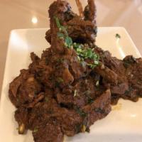 Goat Chops of Heaven · Baby goat chops sauteed with curry leaves, onions, mint and native spices.