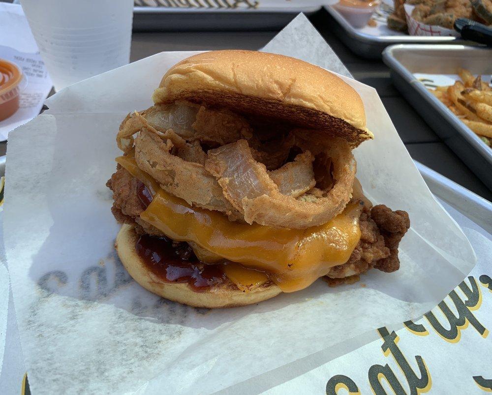 Cheesy BBQ Sandwich · Hand-breaded filet with melted Cheddar, onion rings, and a sweet BBQ sauce. Prepared from scratch on a butter toasted potato bun.