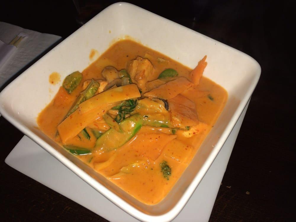 Red Curry · Smooth creamy coconut milk, is matched with hot fiery red chili paste, bamboo shoots, basil, string beans and carrots. Served with jasmine rice.