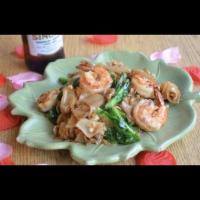 Pad See Ewe · Pan fried wide noodle with soy bean sauce, egg, and chinese broccoli. Your choice of meat, v...