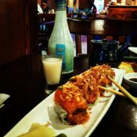 Naughty Girl Roll · Spicy salmon with roasted onion on top with pepper salmon and avocado. Served with chef's fa...