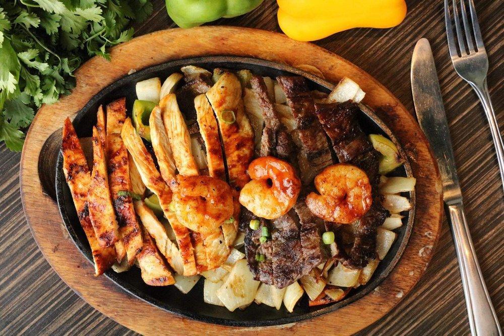 Fajitas · Combination of grilled green peppers and onions with your choice of chicken or steak served with black refried beans, rice and pico de gallo choice of three corn or flour tortillas.