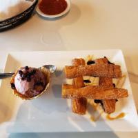 Churros · Fried pastry with black raspberry ice cream and finished with cinnamon sugar.