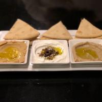 Trio of Spreads Plate · Hummus, baba ghanoush, and labneh served with warm pita.