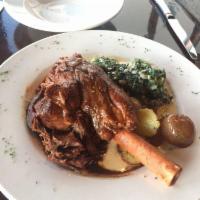 Balsamic Braised Lamb Shank · Deeply caramelized braised lamb shank is served with roasted new potatoes and creamy garlic ...