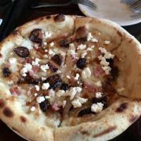 Fig and Pancetta Pizza · Chunks of fig and diced pancetta are paired with caramelized onion, goat cheese, mozzarella,...